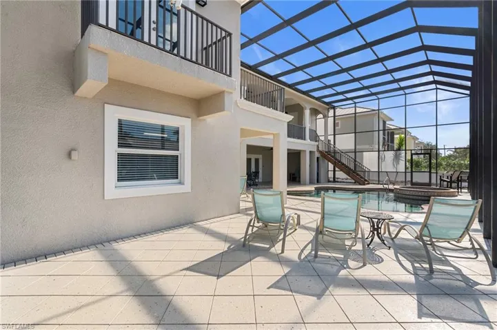 View of patio featuring a swimming pool with hot tub and a lanai