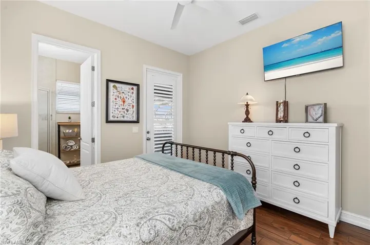 Bedroom with ceiling fan and dark hardwood / wood-style floors