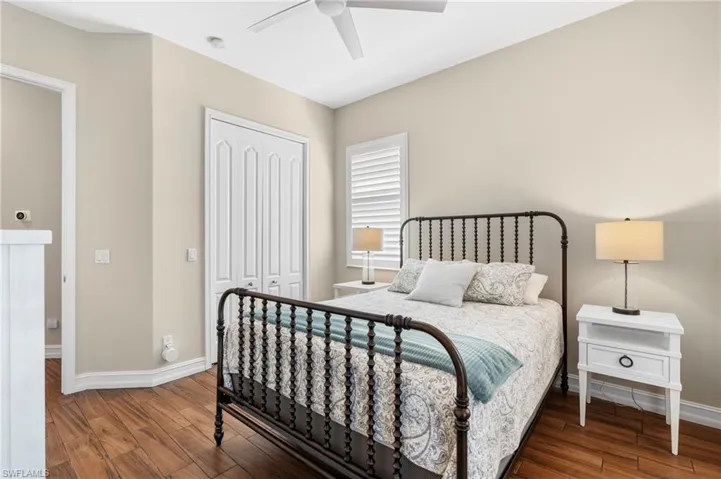 Bedroom with ceiling fan, hardwood / wood-style floors, and a closet