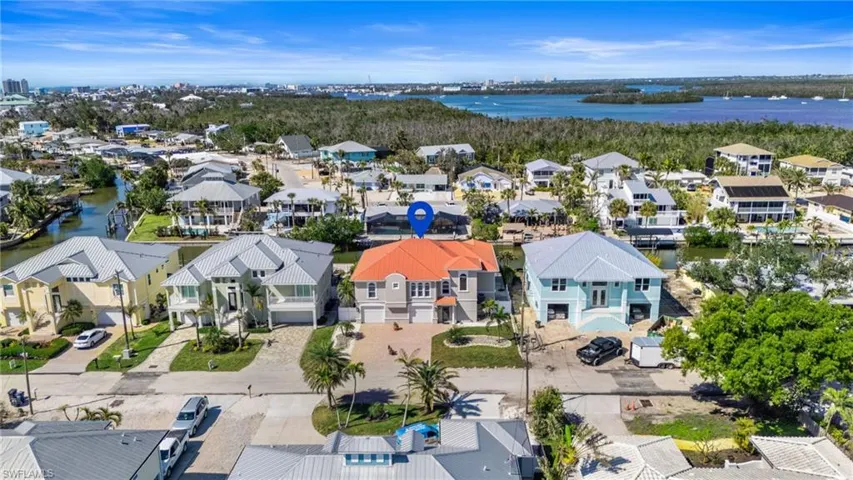 Birds eye view of property with a water view