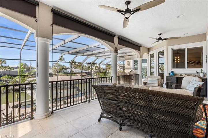 Balcony with spectacular views  with an outdoor living space, ceiling fan, and cage