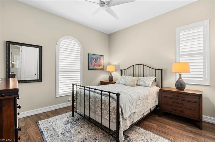 Bedroom featuring ceiling fan and dark hardwood / wood-style flooring