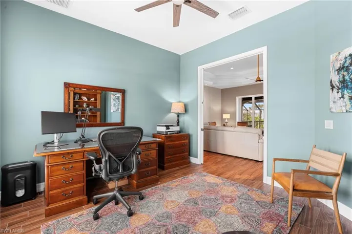 Office featuring hardwood / wood-style flooring and ceiling fan