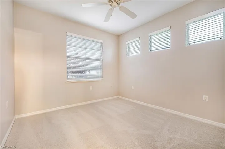 Guest bedroom with neutral carpeting