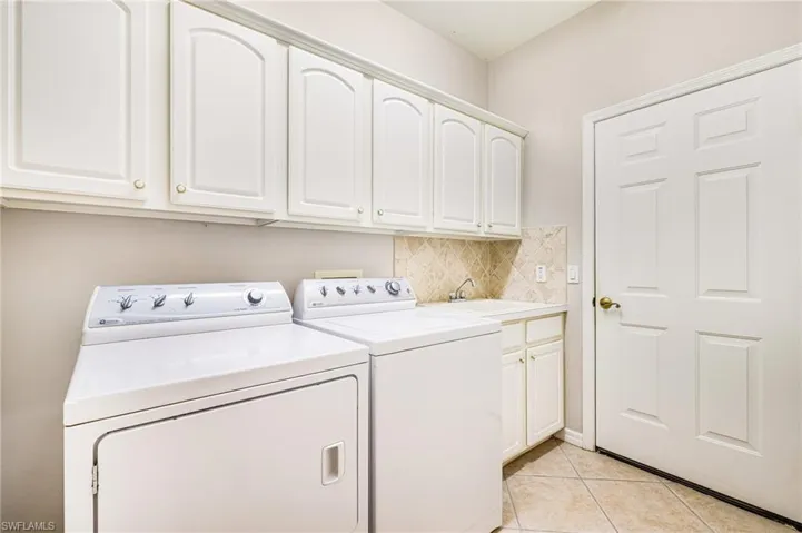 Laundry room with sink and lots of cabinets