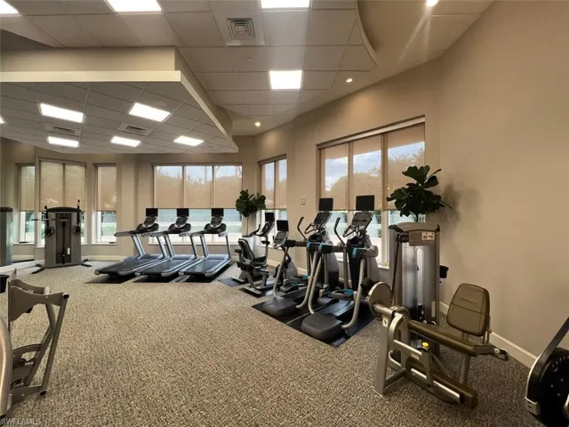 Exercise room with a drop ceiling and carpet