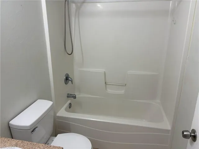 Bathroom featuring vanity and shower / washtub combination