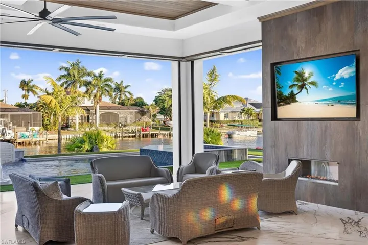 Sitting room with a fireplace and ceiling fan