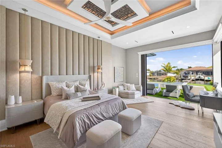 Bedroom featuring coffered ceiling, wood-type flooring, a water view, and crown molding
