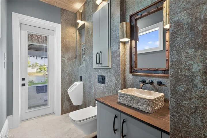 Bathroom with vanity and tile walls