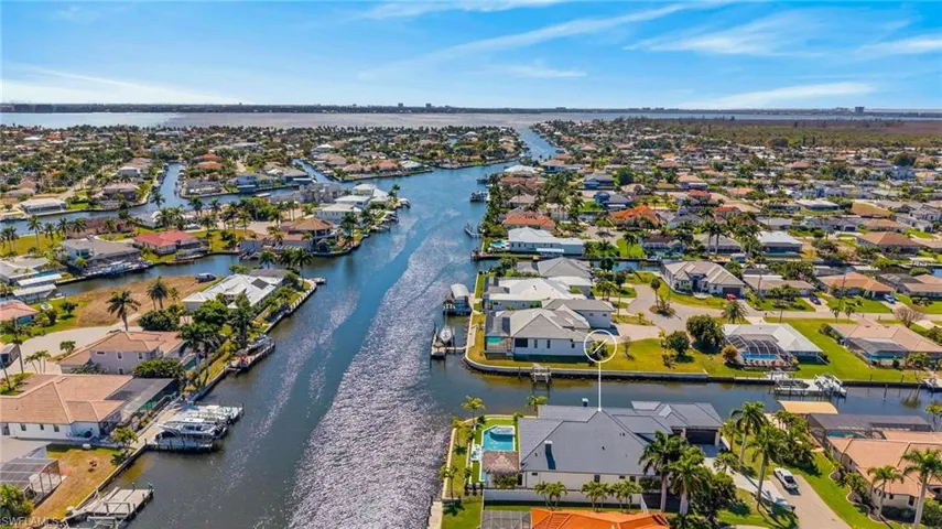 Aerial perspective of suburban area featuring a large body of water