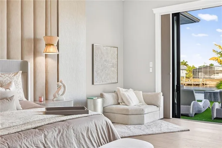 Bedroom with access to outside and wood finished floors