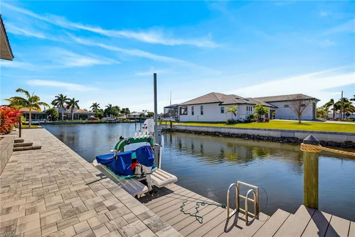 Dock area with a water view and a residential view