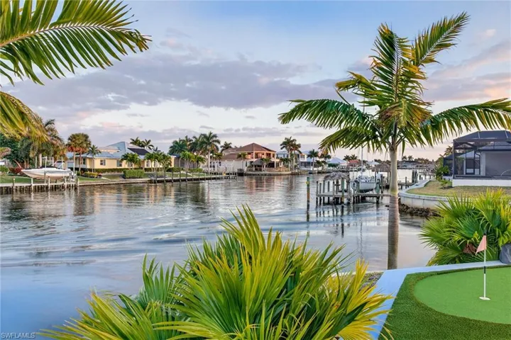 Water view featuring a boat dock and nearby suburban area