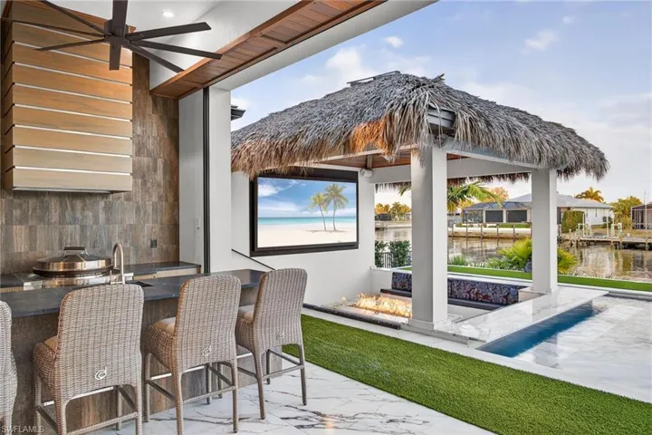 View of patio / terrace featuring an outdoor pool, ceiling fan, and area for grilling