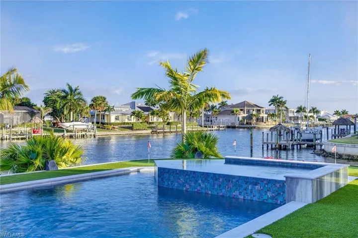 Swimming pool featuring a residential view, a water view, a boat dock, and boat lift