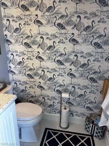 Half bathroom featuring vanity and tile patterned floors