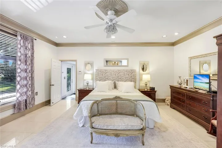 Bedroom with ornamental molding, ceiling fan, light tile patterned floors, and recessed lighting