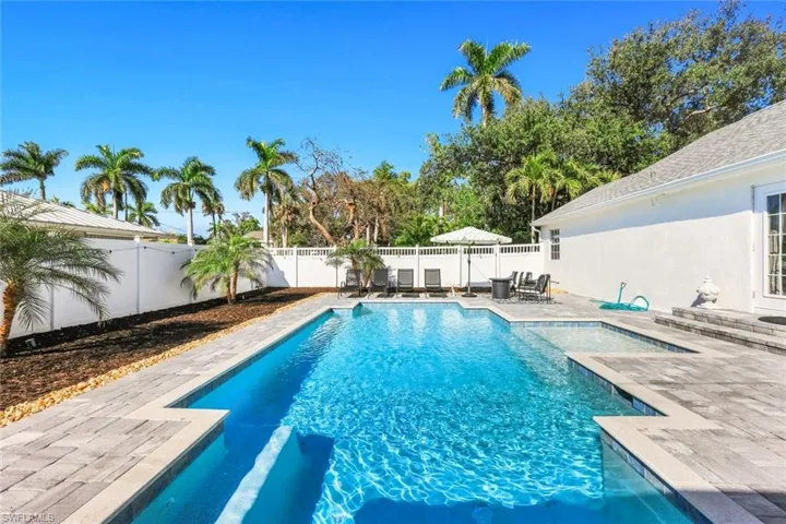 View of swimming pool featuring patio surround and a fenced backyard