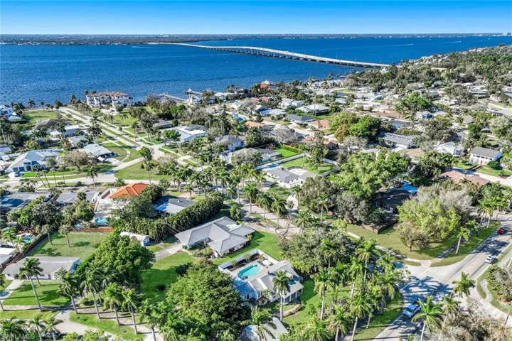 Aerial perspective of neighborhood with a notable bridge and River
