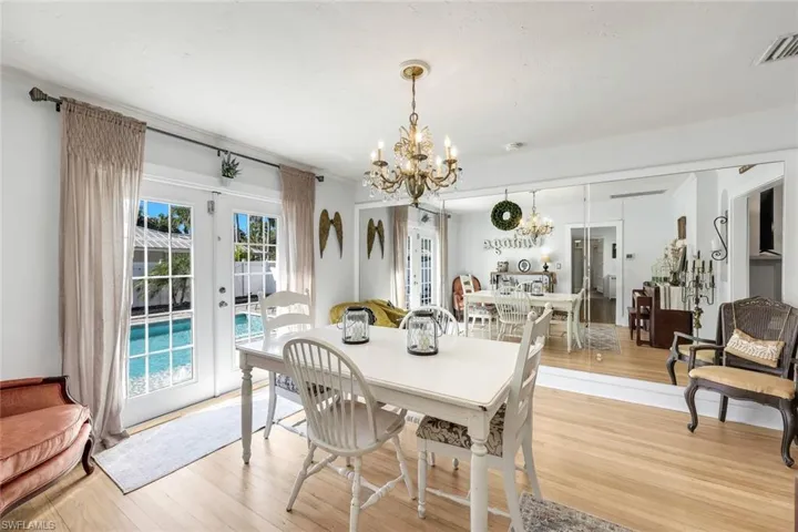 Dining area featuring french doors, suspended lighting, and wood finished floors