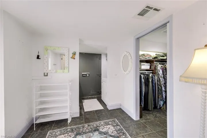 Bathroom featuring a spacious closet and baseboards