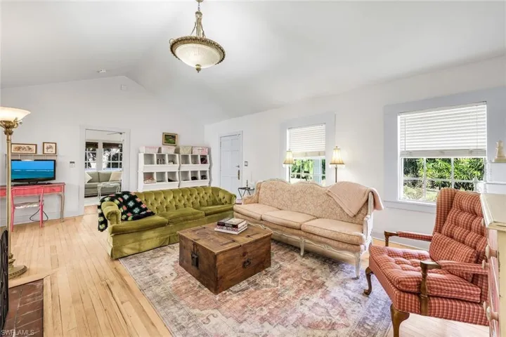 Living room with wood flooring and healthy amount of natural light