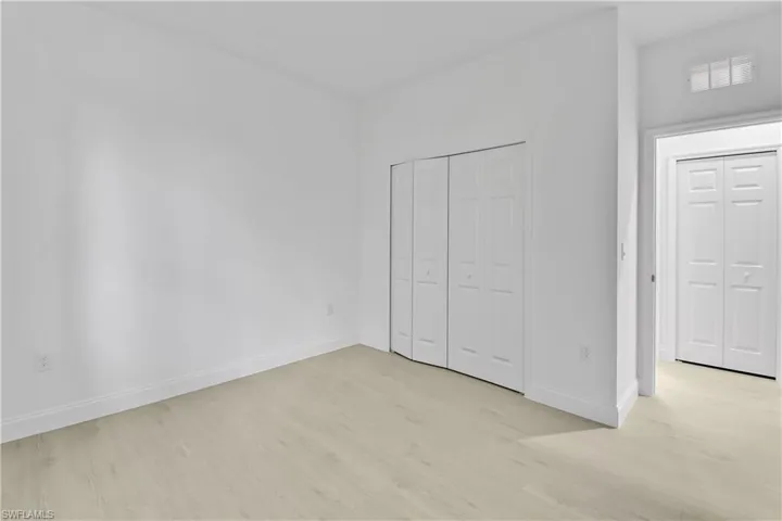 Unfurnished bedroom featuring light wood finished floors and a closet