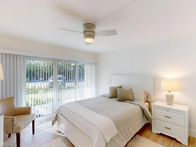 Bedroom featuring ceiling fan, light wood-type flooring, and access to exterior