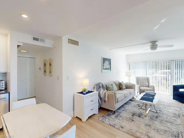 Living room with light wood-type flooring and ceiling fan