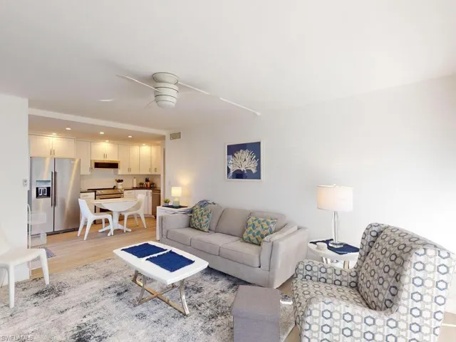 Living room featuring light hardwood / wood-style flooring and ceiling fan