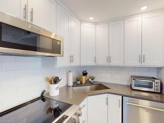 Kitchen with white cabinets and stainless steel appliances