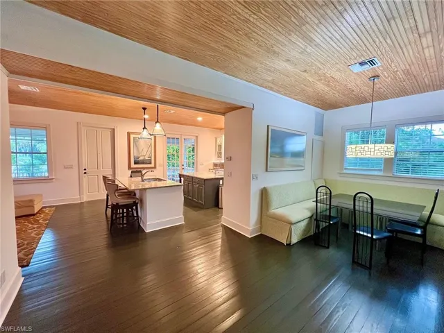 Dining area featuring wooden ceiling and dark wood-style flooring