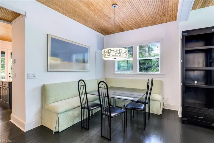 Dining area featuring dark wood-style floors, wood ceiling, and breakfast area