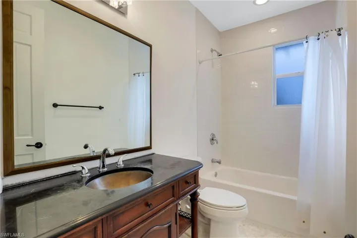 Full bath with shower / bathtub combination with curtain and vanity