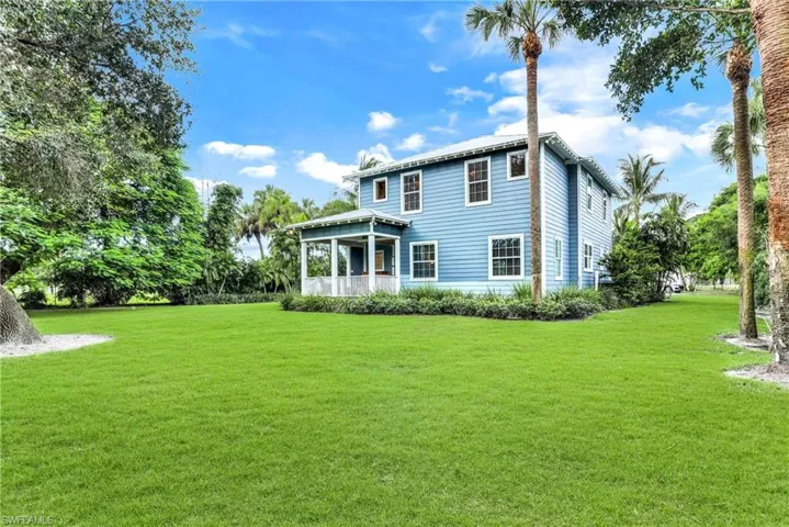 Rear view of house with a yard