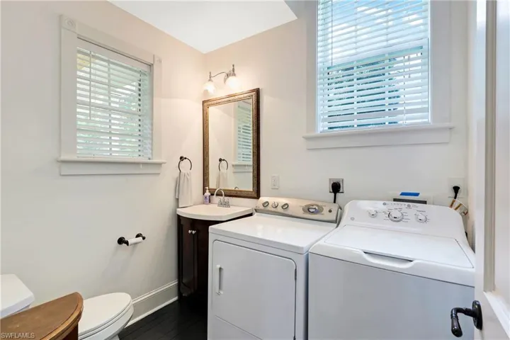 Laundry area featuring baseboards and washing machine and clothes dryer