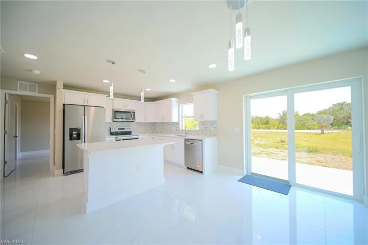 The Island Kitchen Comes With Stainless Steel Appliances, Tile & Glass Backsplash, Quartz Countertops, White Real Wood Soft Closing Cabinets & Drawers, Custom Lighting, And A Large Walk-In Pantry!