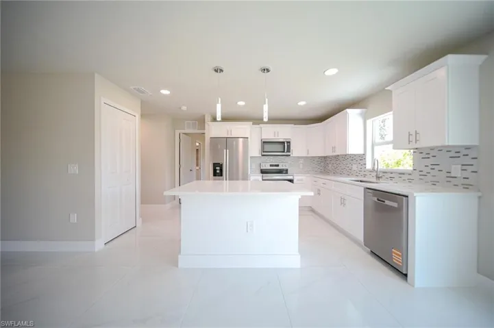 The Island Kitchen Comes With Stainless Steel Appliances, Tile & Glass Backsplash, Quartz Countertops, White Real Wood Soft Closing Cabinets & Drawers, Custom Lighting, And A Large Walk-In Pantry!