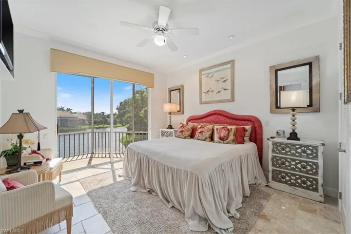 Bedroom with ornamental molding, access to outside, a water view, and a ceiling fan