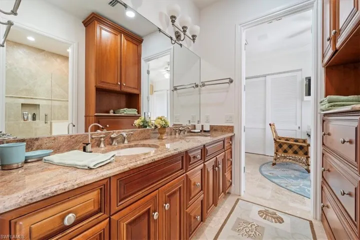 Bathroom with double vanity and a shower stall
