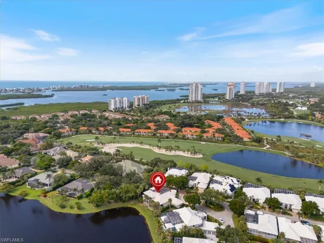 View of property location with a large body of water, a golf club, and nearby suburban area