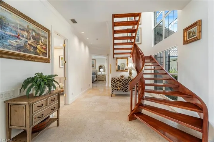 Staircase with ornamental molding and recessed lighting