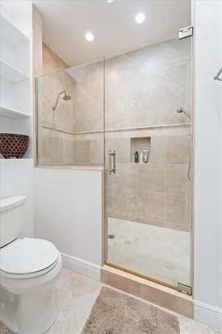 Full bathroom with a shower stall, tile patterned floors, and recessed lighting