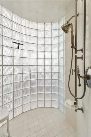 Bathroom featuring a tile shower and light tile patterned flooring