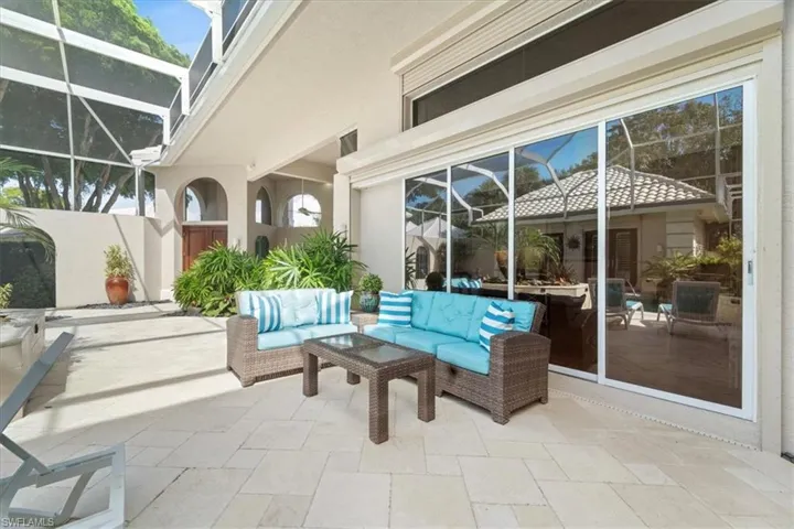 View of patio with glass enclosure and a sunroom