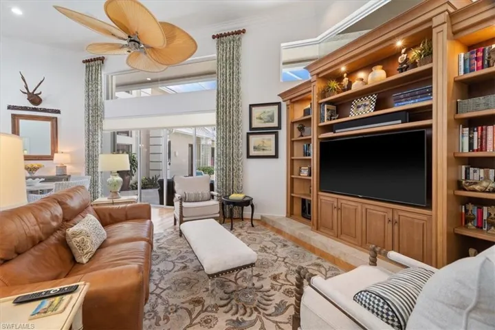 Living room featuring ornamental molding and ceiling fan