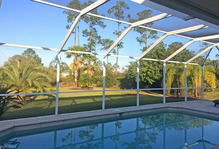 View of swimming pool with a lawn