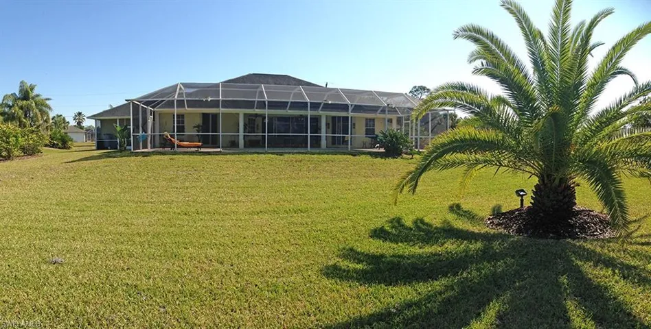 View of yard with glass enclosure