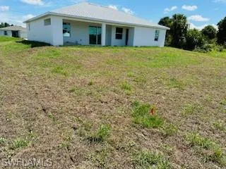 Rear view of house with a lawn
